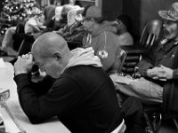 Mike Silvia and fellow veterans living at the Veterans Transition House in New Bedford listen to a guest speaker tell his story of his battle with PTSD and addiction.   PHOTO PETER PEREIRA